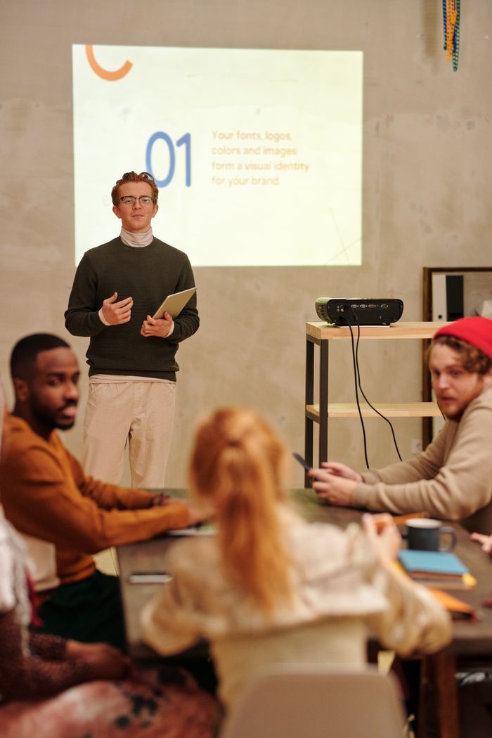 Diverse team engaged in a presentation with visual aids in a modern office.